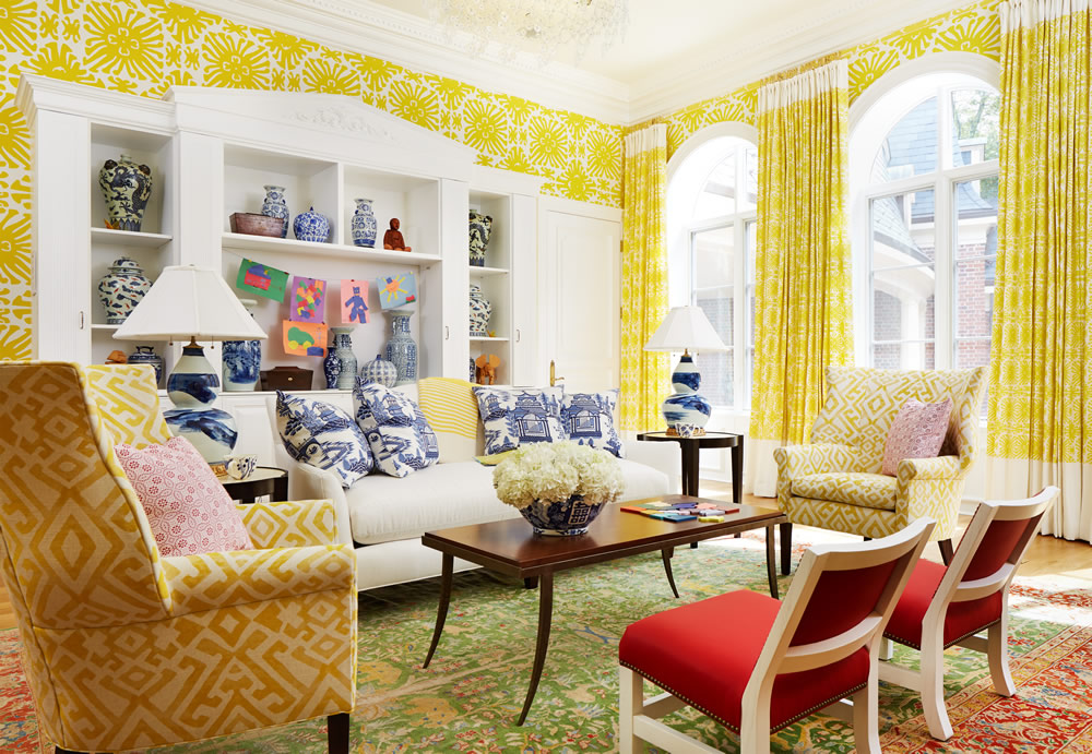 Quadrille wallpaper in living room with red chairs.