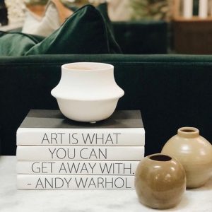 Art quote made up of decorative bound books.