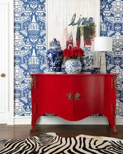 Beautiful red cabinet, with red accents and in the art, adding dramatic boldness to the space.