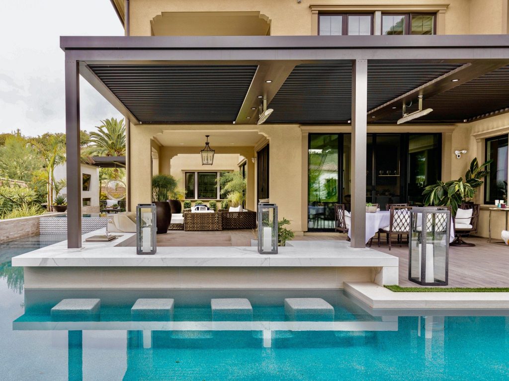 A pergola adds shade covering to the pool area.