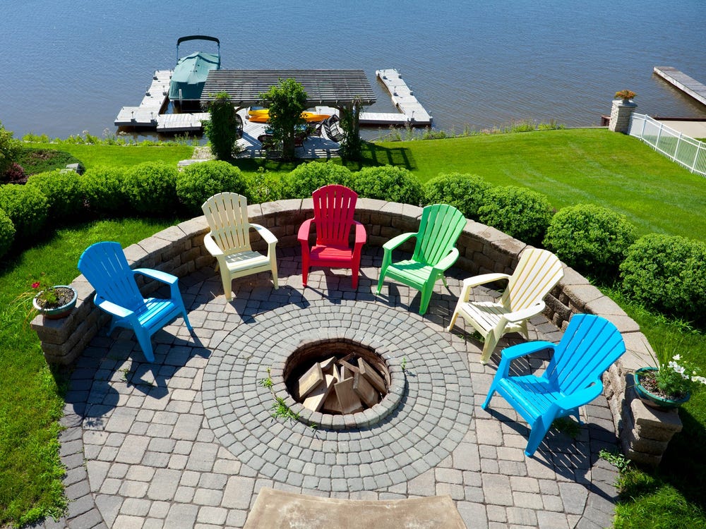 A half wall and a stone patio create the space.