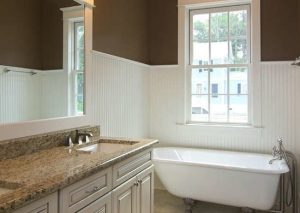 The white beadboard and chair rail brighten up the bathroom, and in combination with the ceiling trim creates the effect of taller ceilings and a brighter bathroom.