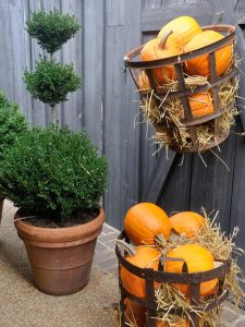 Lightweight faux pumpkins can decorate your door and your entry way.
