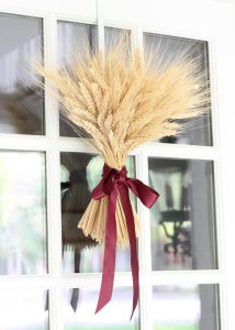 A gathering of ribbon-tied wheat will wow your door for fall.