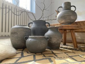 Groupings of vintage vessels add warmth and craft to fall design styling.