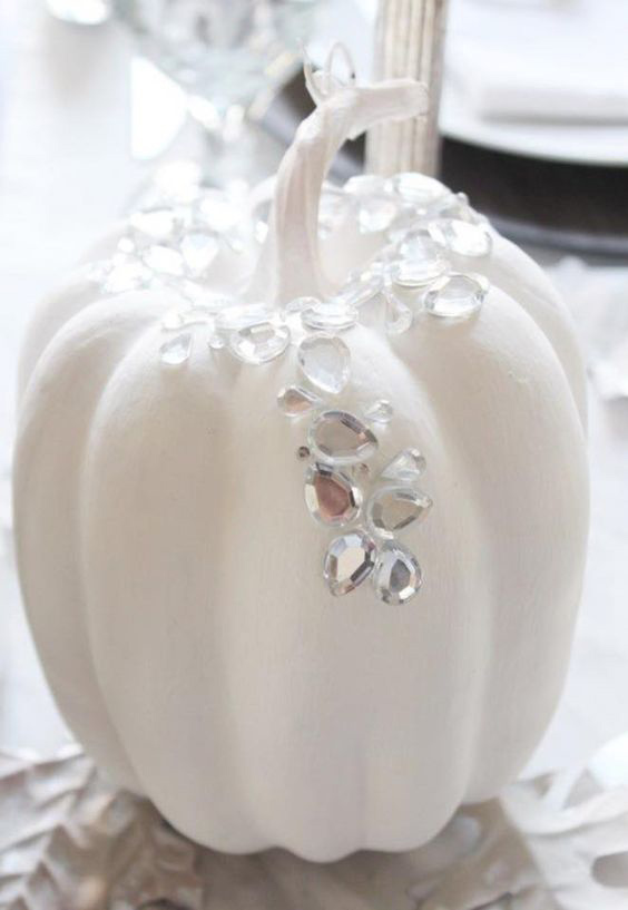 Simple additions bring a luxurious holiday vibe to a white pumpkin.