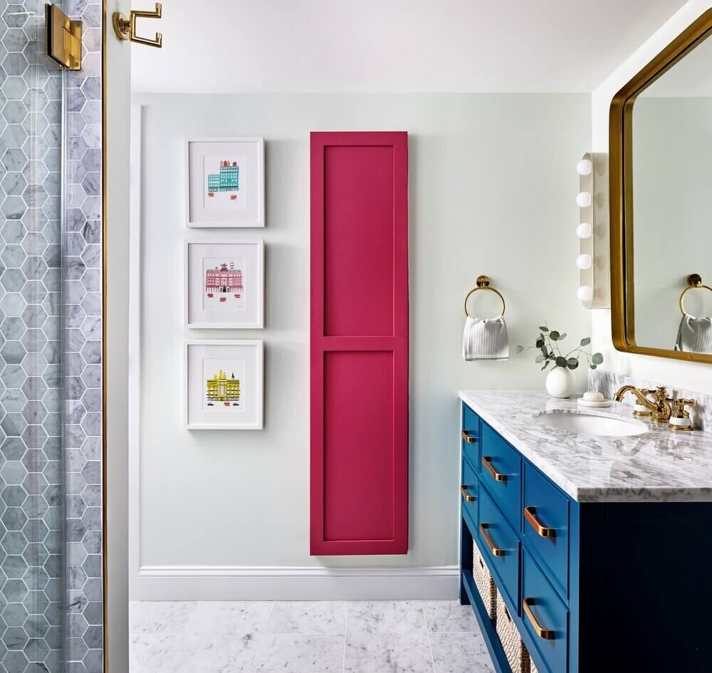 Viva Magenta adds the right amount of pop in this already colorful bathroom. It's very much at home with the rich blue and other accent colors.