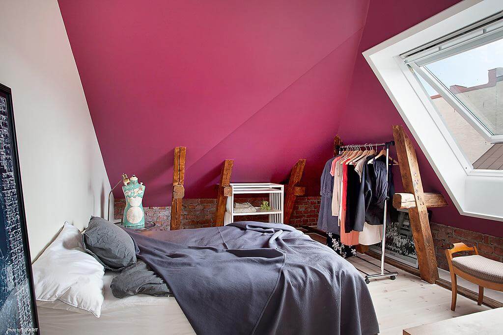 You can paint the walls Viva Magenta for a bright colorful effect, as this attic bedroom shows.