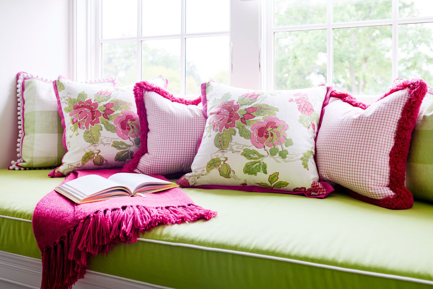 Viva Magenta pillows and a throw mix it up with green in a traditional living room setting.