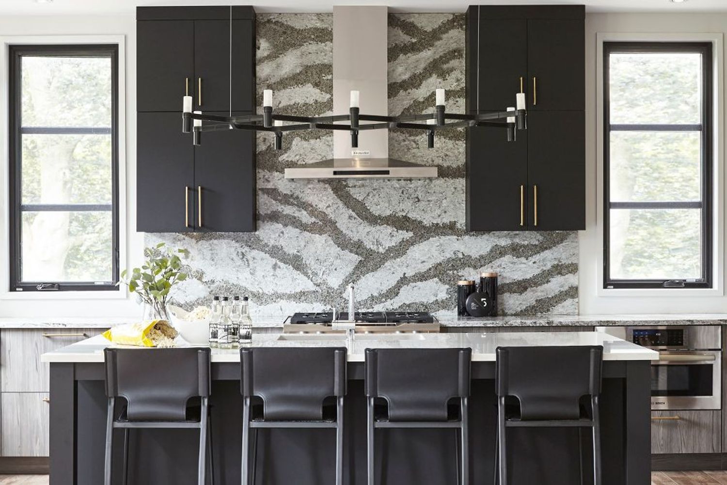 A boldly-patterned quartz backsplash is a hot item in 2023 kitchen trends.