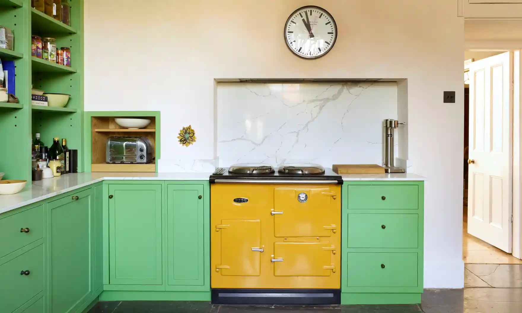 Statement appliances are creating loud and proud color accents in 2023 kitchen designs.