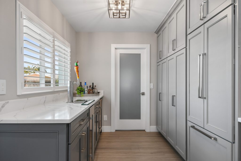 The door was reconfigured to the center of the wall and additional cabinetry was added to make this small space come alive.