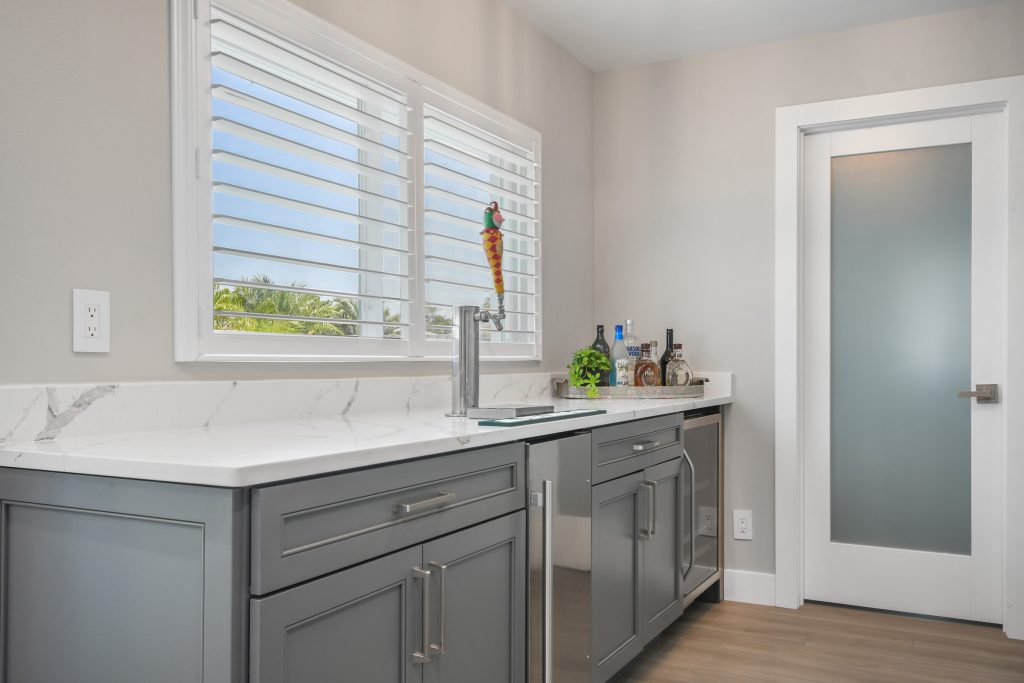 This newly remodeled area now boasts a wine fridge, a kegerator, as well as a pantry on the opposite wall.