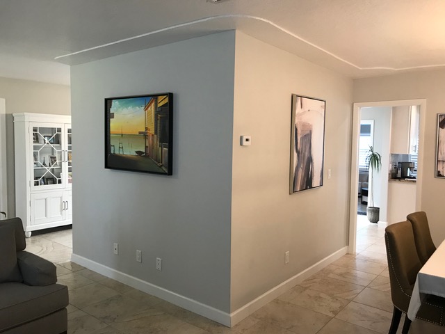 This L-shaped wall detracted from the living area and making the space seem small.