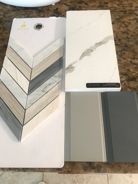 We selected a natural stone quartz countertop, not just for its beauty, but for its practicality as well. Kitchen cabinets in two tones–gray and moonstone, and a herringbone-patterned backsplash all bring the desired look together.