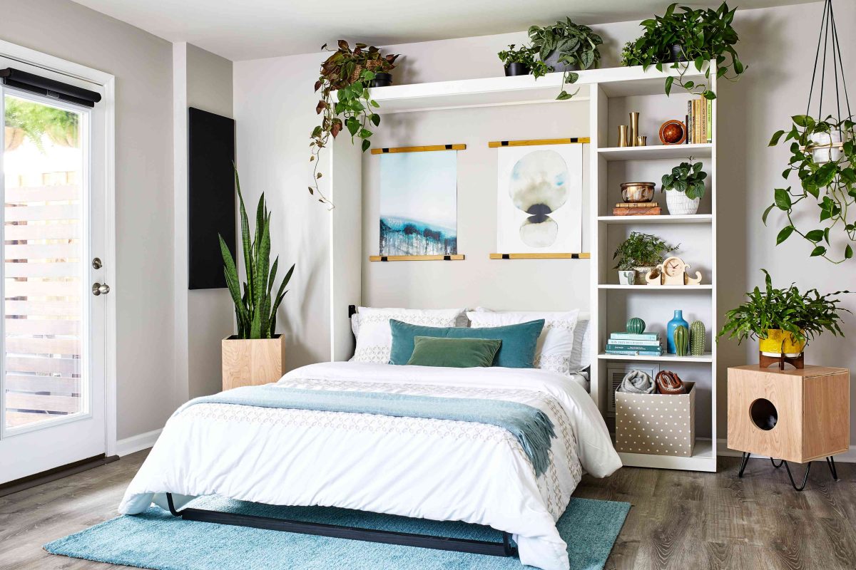 Murphy bed set into wall unite cabinet system with many "homey" touches.