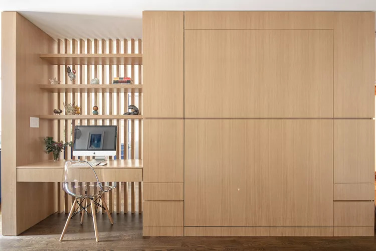 Stylish home office with Murphy bed installed in cabinetry, in "closed" mode.