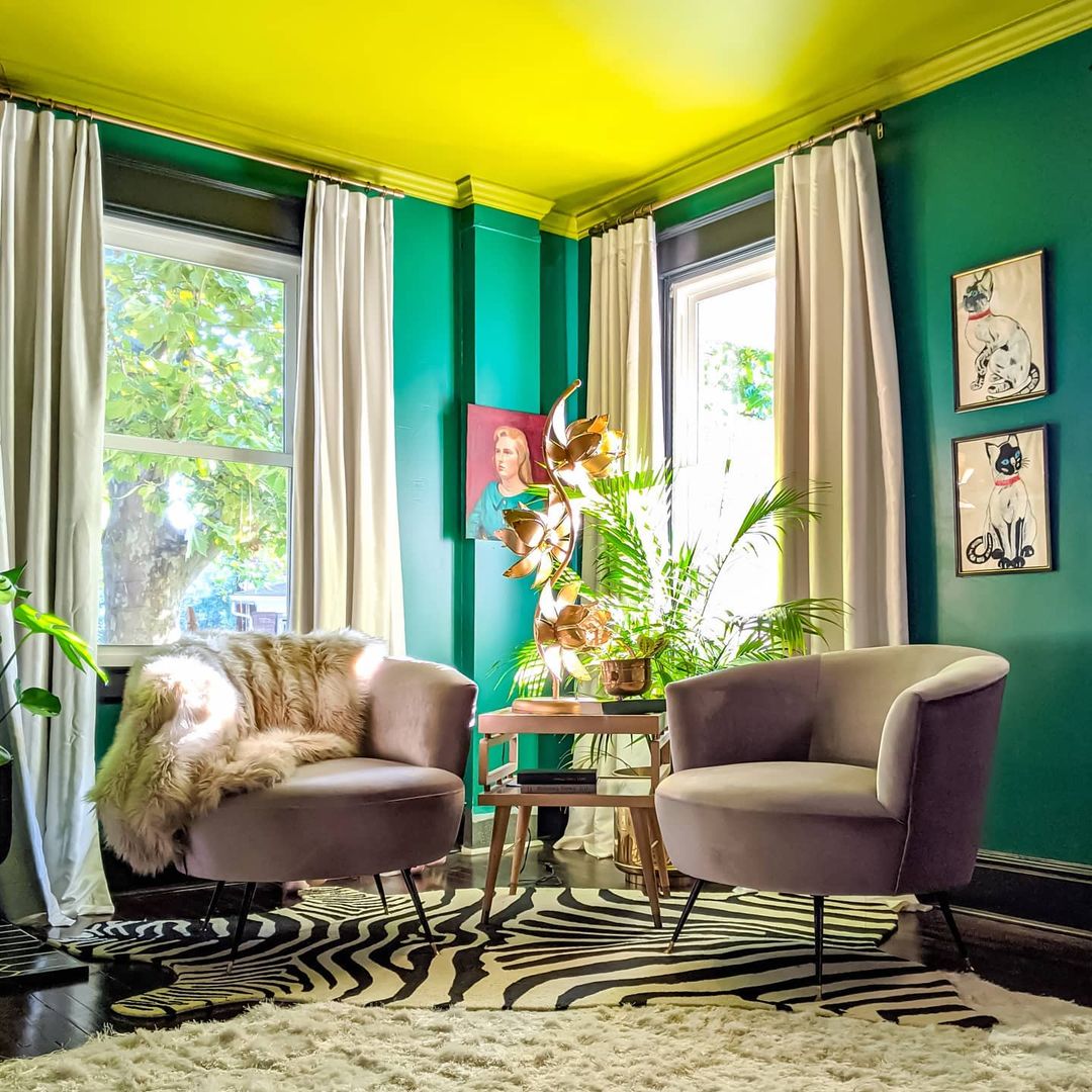 This near-yellow ceiling is painted in Offbeat Green, and is grounded by being paired with a deeper green wall color, Starboard.