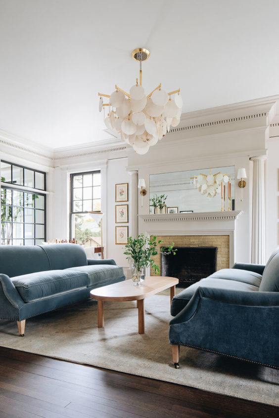 Choosing natural fabrics with weight and texture, like chunky cotton and wool throws, nubby boucle, velvet, leather, and weightier linen pieces instantly make your home feel cozier — even if you prefer a cooler color palette.