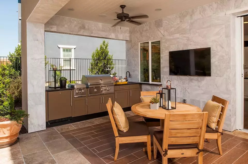 Consider setting up a hot beverage station in your outdoor kitchen to feel cozier while spending time in your outdoor living space.
