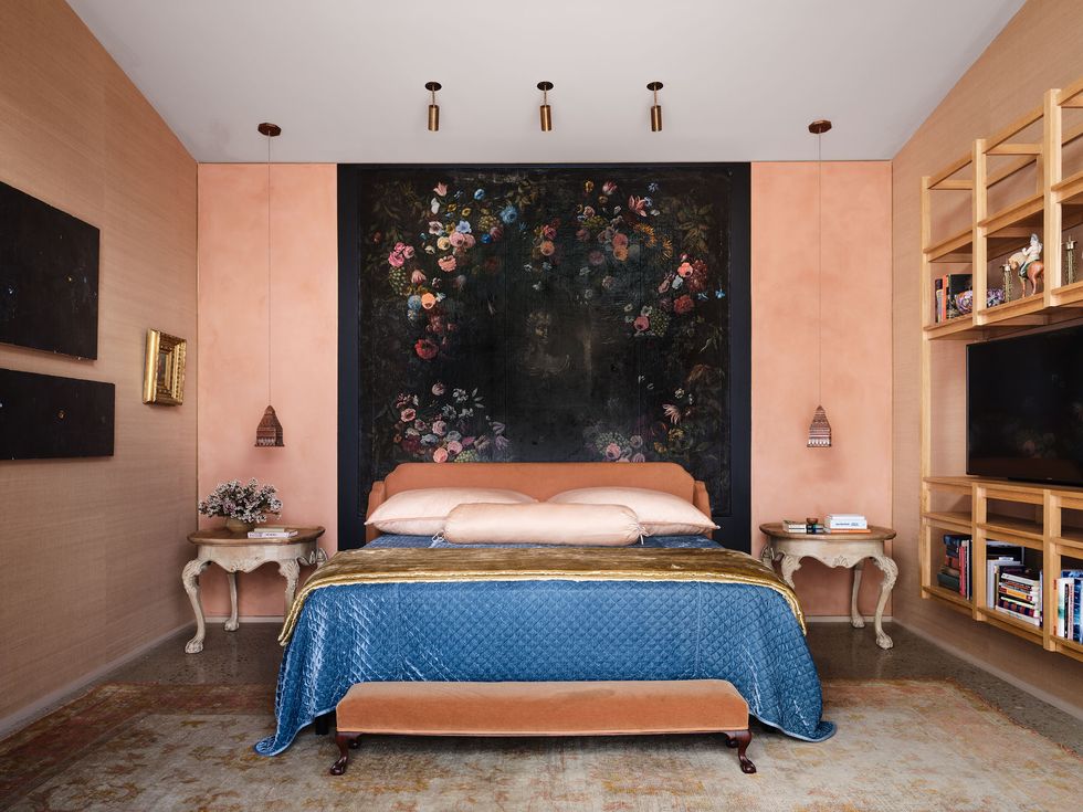In a San Antonio house, the back bedroom wall is painted in a flattering peach plaster (much like the Pantone 2024 Color of the Year, Peach Fuzz), while the other surfaces are clad in a matching grasscloth wallcovering.