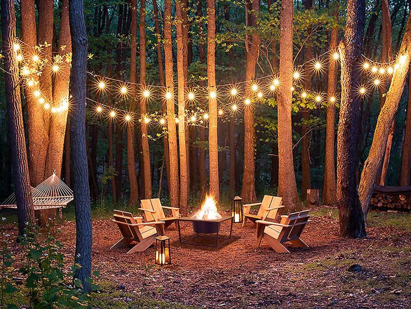 APQQZVYLMBF4XAZBUDPK6GNZ3M Hanging string lights from tree to tree is an instant mood lifter for any outdoor space.