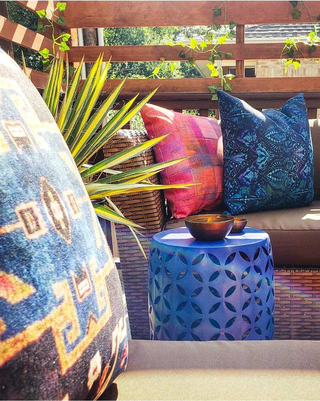brighten-deck-with-colorful-pillows Layering in a few pillows in bright colors and fun patterns will give your patio a fresh look.