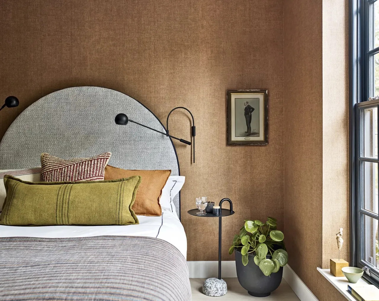 This is a contemporary bedroom but the use of rich tones, shapes, and details creates a connection with nature that makes it appear almost timeless.