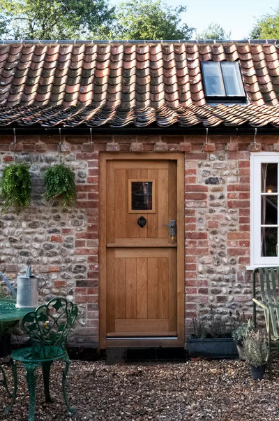 Instead of paint, traditional stained wood doors are making a comeback.