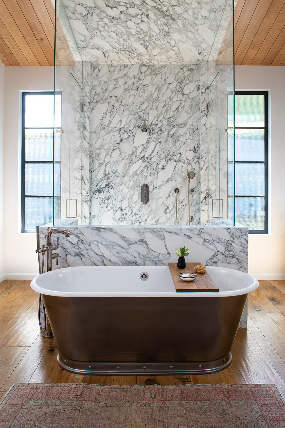 Marble slab showers are replacing traditional tiled designs for an elegant, seamless look.