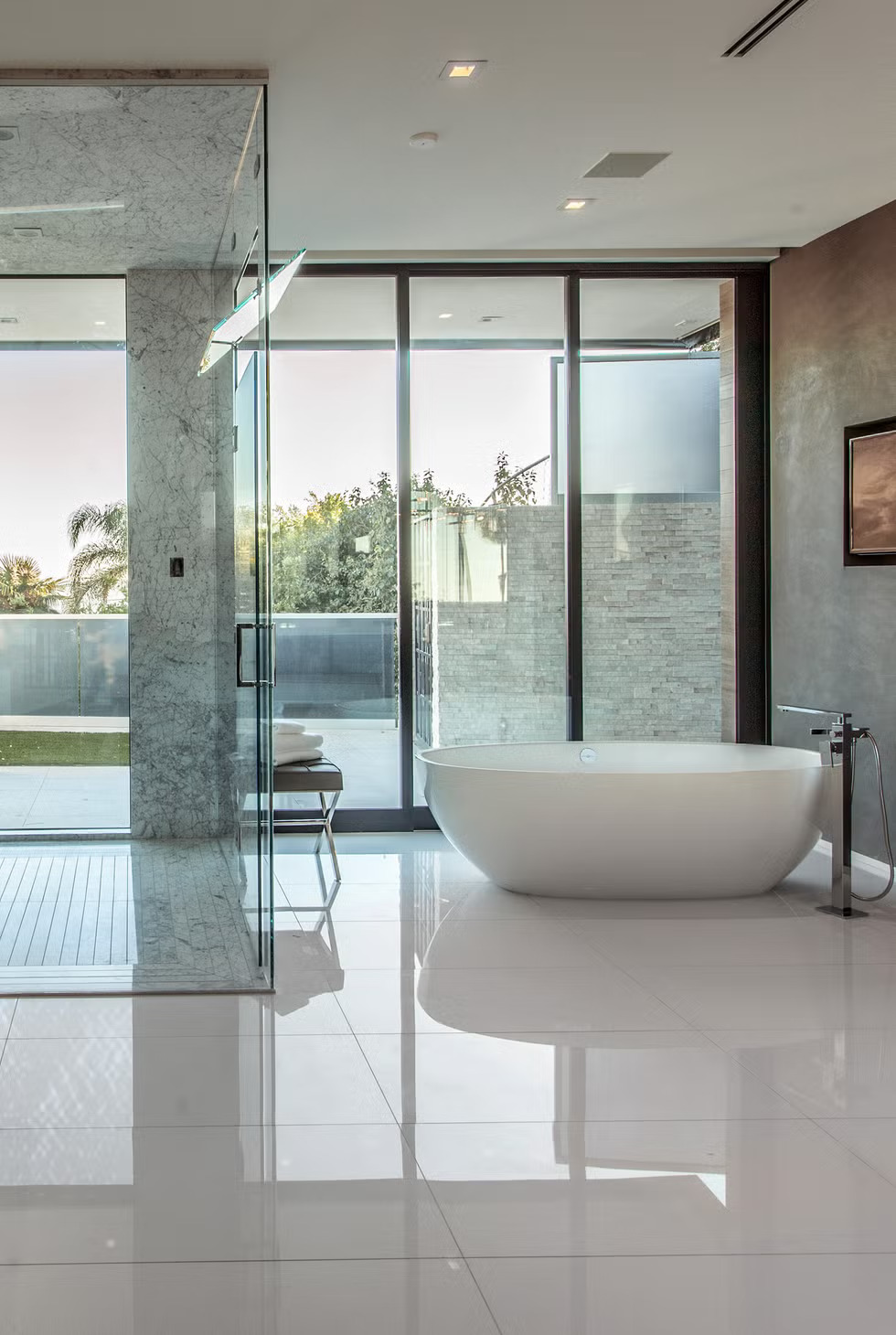 Organic materials like natural stone, ambient lighting, and freestanding tubs create luxurious spaces designed for relaxation.